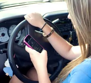 summer accidents - teen girl texting while driving